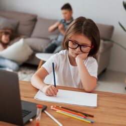 Doing homework. Kids having fun in the domestic room at daytime together