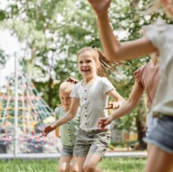 Group of kids playing at the playground in summer day